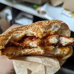 a hand holding a sandwich