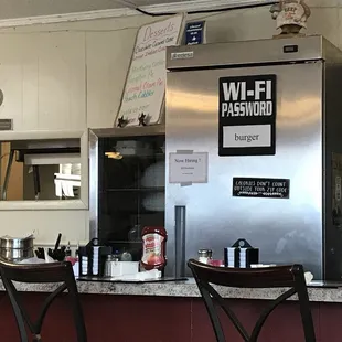 a stainless steel refrigerator and bar stools
