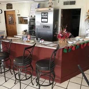 a kitchen with a counter and stools