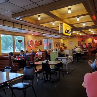 people sitting at tables in a restaurant
