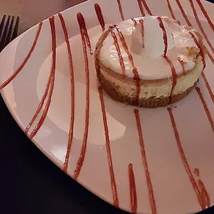 A baked cheesecake with raspberry drizzle