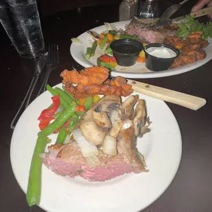 Prime rib, mushroom and onion topping, sweet potato fries, cooked vegetables.