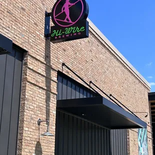 a neon sign for hi - wire brewing