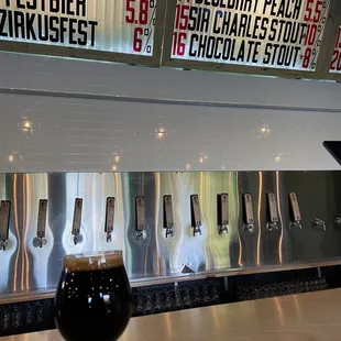 a glass of beer on a bar