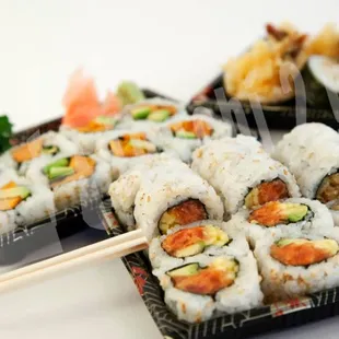 a tray of sushi and chopsticks