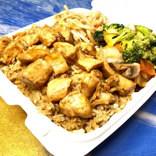 a takeout container of chicken and rice