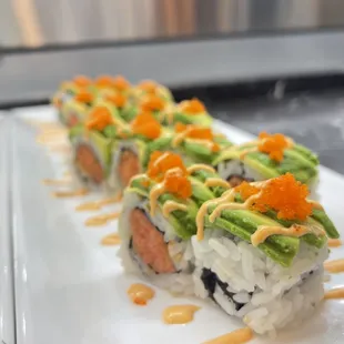  a sushi roll with avocado and salmon