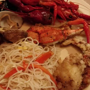 a plate of seafood and noodles