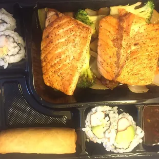 $9 salmon hibachi bento box (salmon on a bed of sautéed vegetables, California rolls, egg roll and rice either a soup or salad)