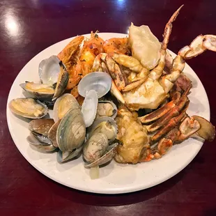 Variety of seafood for dinner. Favorite is salt and pepper shrimp (back). Unfortunately the clams weren&apos;t the freshest.