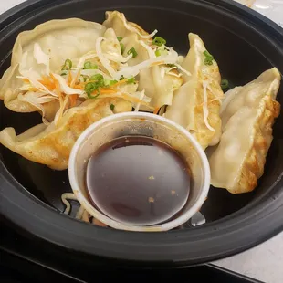a plate of dumplings and sauce
