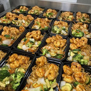 Garlic butter shrimp with noodles, fried rice and veggies