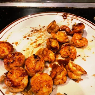 a plate of food with shrimp and broccoli