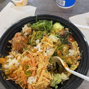 Spicy Crab and Spicy Tuna with rice. Mixed with Cilantro and fresh Seaweed. Slice avocado on the side.