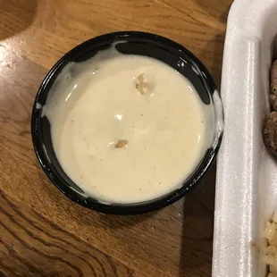 a plate of food and a bowl of sauce