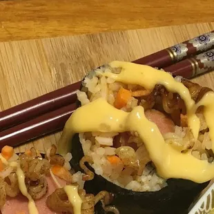 Sushi roll with the infamous sakura sauce (egg yolk sauce).
