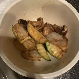 a bowl of mushrooms and zucchini