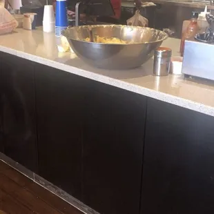 A batch of uncovered and unattended garlic butter sitting on their counter.
