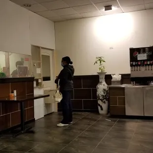 a woman standing in a kitchen