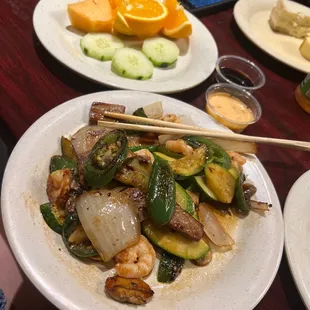 a plate of food with chopsticks