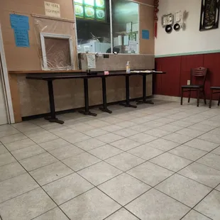 a kitchen with tables and chairs