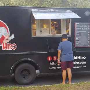 a man standing in front of the truck
