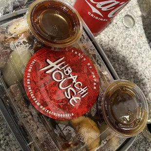 a tray of food and a can of soda