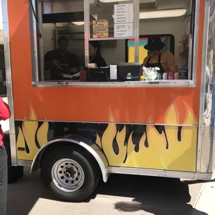 a man standing in front of a food truck