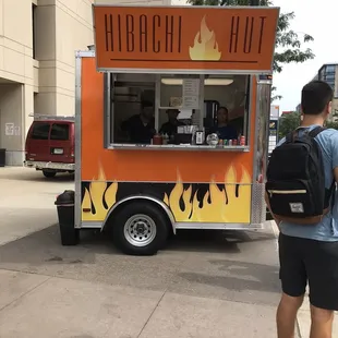a man standing in front of a food truck