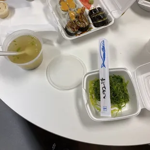 Miso soup, seaweed salad and two lunch rolls.