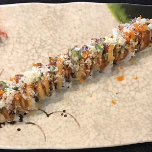 The VALRICO Roll with chicken tempura, bacon, and cream cheese inside, and spicy mayo, eel sauce, crunchy, scallion and tobiko on top.