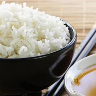 a bowl of rice and chopsticks