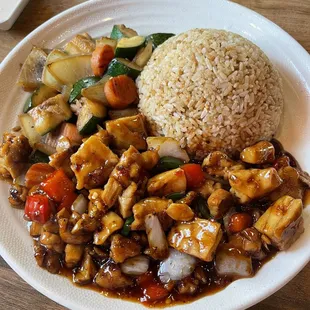 A volcano chicken hibachi plate with fried rice and vegetables.