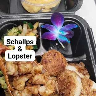 a tray of food with shrimp and vegetables