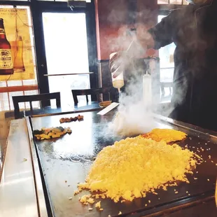 a man cooking food on a grill