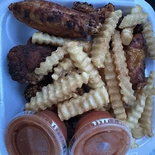 ows chicken and waffle fries in a styrofoam container