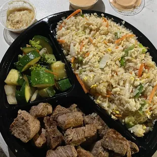 Filet Mignonette with fried rice and fresh zucchini, broccoli, onion and carrots.