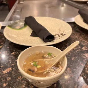 a bowl of soup and a plate of rice