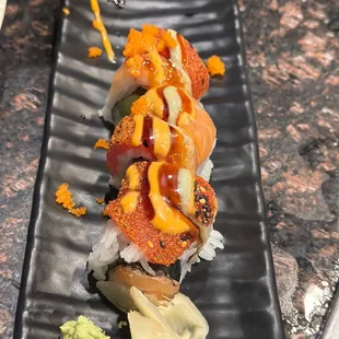 a sushi roll on a black plate