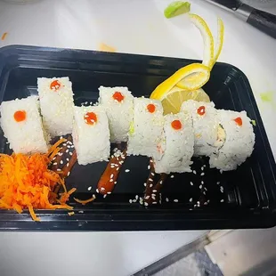 California roll 
IN: spicy mayo, crab, cucumber and avocado.
Out: Sriracha and sesame seeds