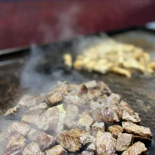 beef being cooked on a grill
