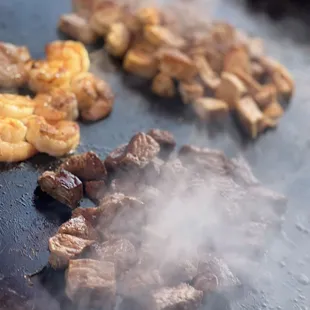 steaks being cooked on a grill