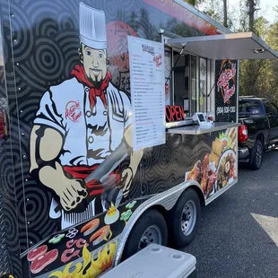 a food truck with a chef on it
