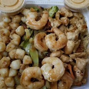 shrimp, broccoli, and rice in a styrofoam container