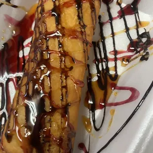 Deep fried Cheesecake with chocolate, raspberry, and caramel syrups