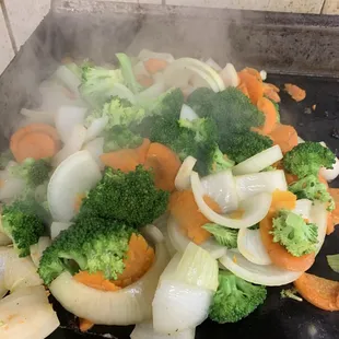 a mixture of vegetables being cooked