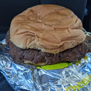 a hamburger on aluminum foil