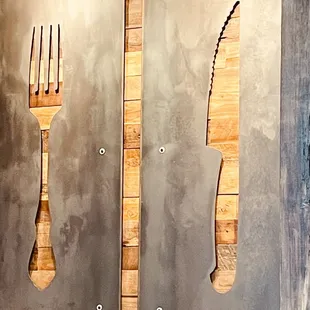 a fork and knife on the wall