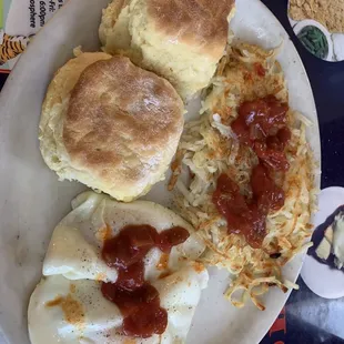 Hash browns, 2 eggs over easy and biscuits and gravy. (Gravy not included in phot)