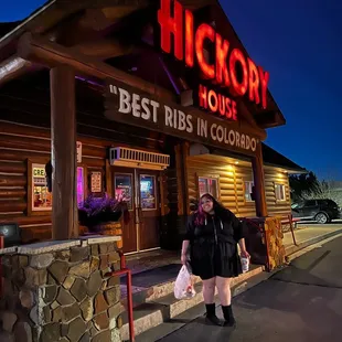 a man standing in front of the restaurant